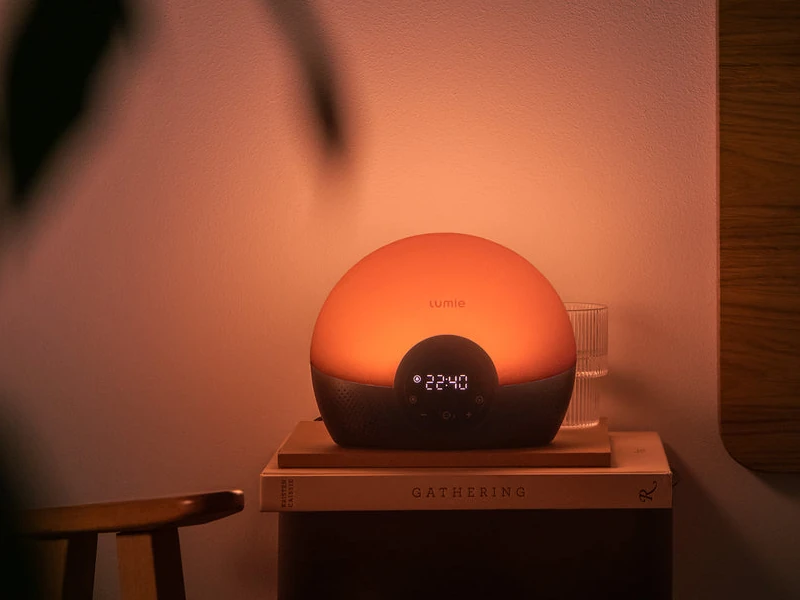 Exact Lumie Bodyclock Glow 150 glowing on a bedside table with its display and controls visible