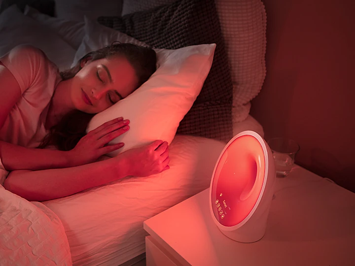 Exact Philips SmartSleep HF3650/60 glowing red beside a sleeping person