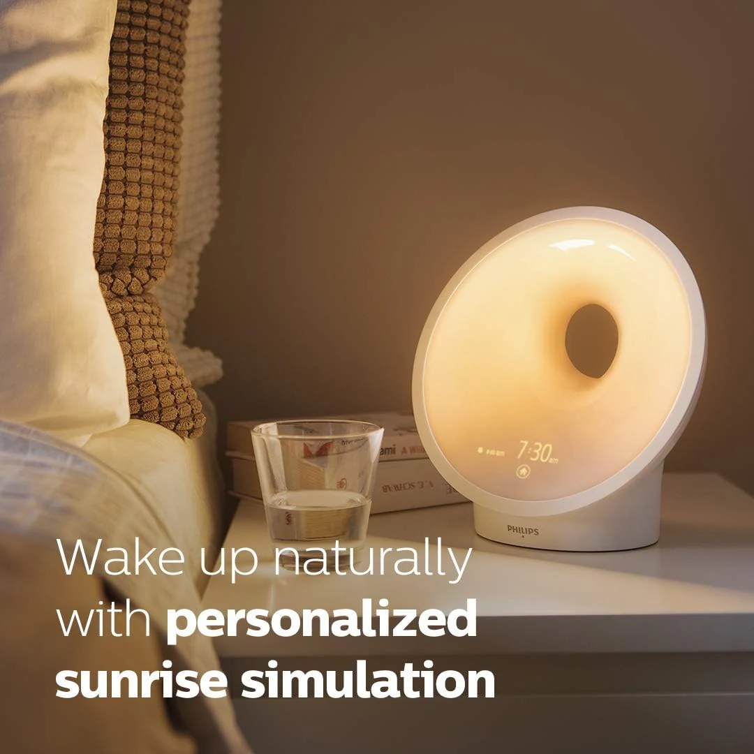 Exact Philips SmartSleep HF3650/60 glowing beside a bed for the full review