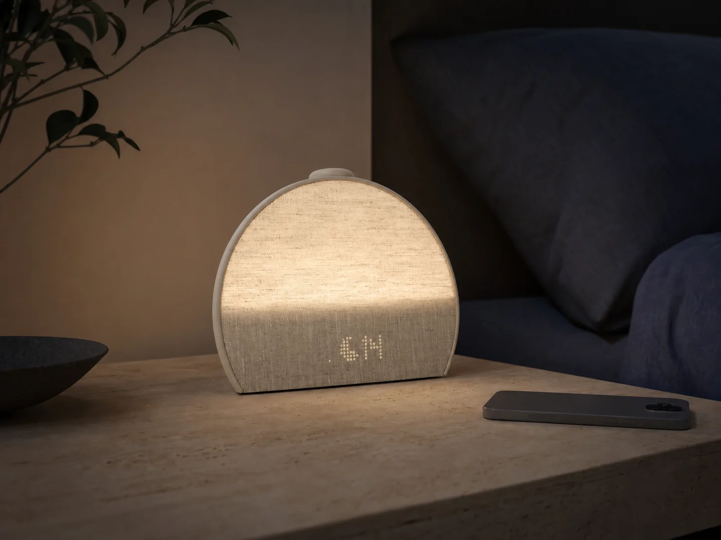 Putty fabric Hatch Restore 3 sunrise alarm clock glowing on a bedside table