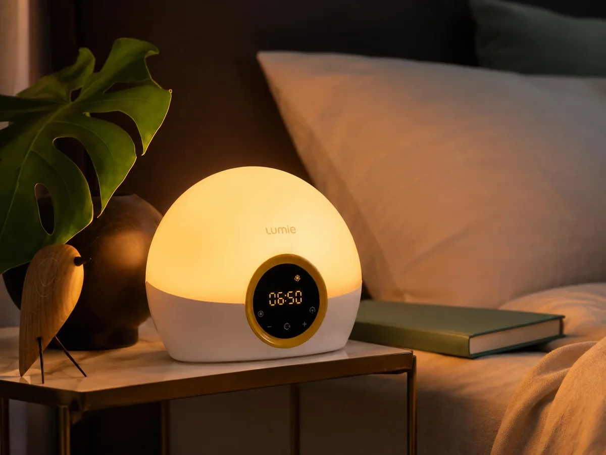 Exact Lumie Bodyclock Rise 100 glowing on a bedside table with its full body visible